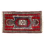 A red ground Afghan rug, with symmetrical pattern, 198cm x 103cm