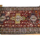A large red and cream ground Afghan design carpet, 336cm x 184cm