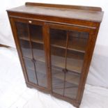 A 1920s oak bookcase with 2 lattice-glazed doors, W89cm, H124cm, D30cm