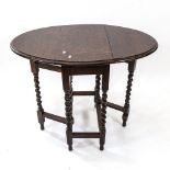 A small oak oval gateleg table, on barley twist legs, W60cm, H70cm, D33cm