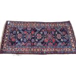A blue ground Persian design runner, with symmetrical pattern, 235cm x 115cm