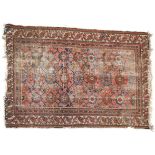 An Antique red ground Persian rug, with symmetrical pattern, 185cm x 126cm