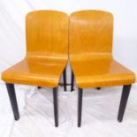 A pair of mid-century design bent-plywood side chairs, on ebonised wood base, in the manner of