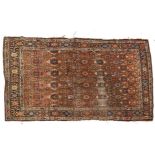 An Antique red ground Persian rug, 190cm x 118cm