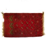A small red ground Turkemon rug, 124cm x 80cm