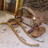 A pair of Vintage cast-iron bird of prey stands, and a pair of brass horse haynes