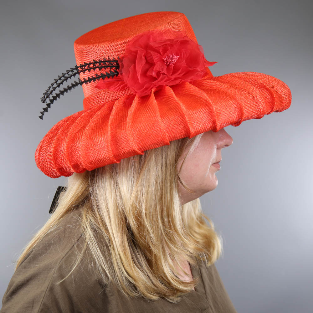 PETER BETTLEY LONDON - Coral red occasion hat, with flower and black feather detail, angled crown, - Image 7 of 7