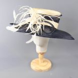 A HAT STUDIO DESIGN - Navy blue and straw occasion hat, with feather and twirl detail, internal