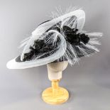 PETER BETTLEY LONDON - Black and white occasion hat, with flower and frayed mesh detail, internal