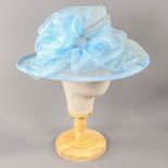 A HAT STUDIO DESIGN - Powder blue occasion hat, with organza bow, internal circumference 55cm,