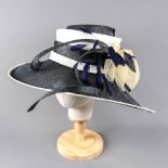 PETER BETTLEY LONDON - Navy blue and cream large brim occasion hat, with bow and feather details,