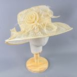 SUZANNE BETTLEY - Champagne occasion hat, with flower and frayed mesh detail, internal circumference