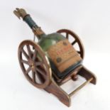 A table cannon, containing an empty bottle of Courvoisier Cognac with eagle stopper, length 56cm