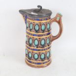 A Wedgwood Majolica pottery jug, with pewter lid and relief moulded motto, height 21cm