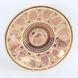 WILLIAM DE MORGAN for WEDGWOOD - a purple lustre glazed pottery charger, floral decoration, Wedgwood