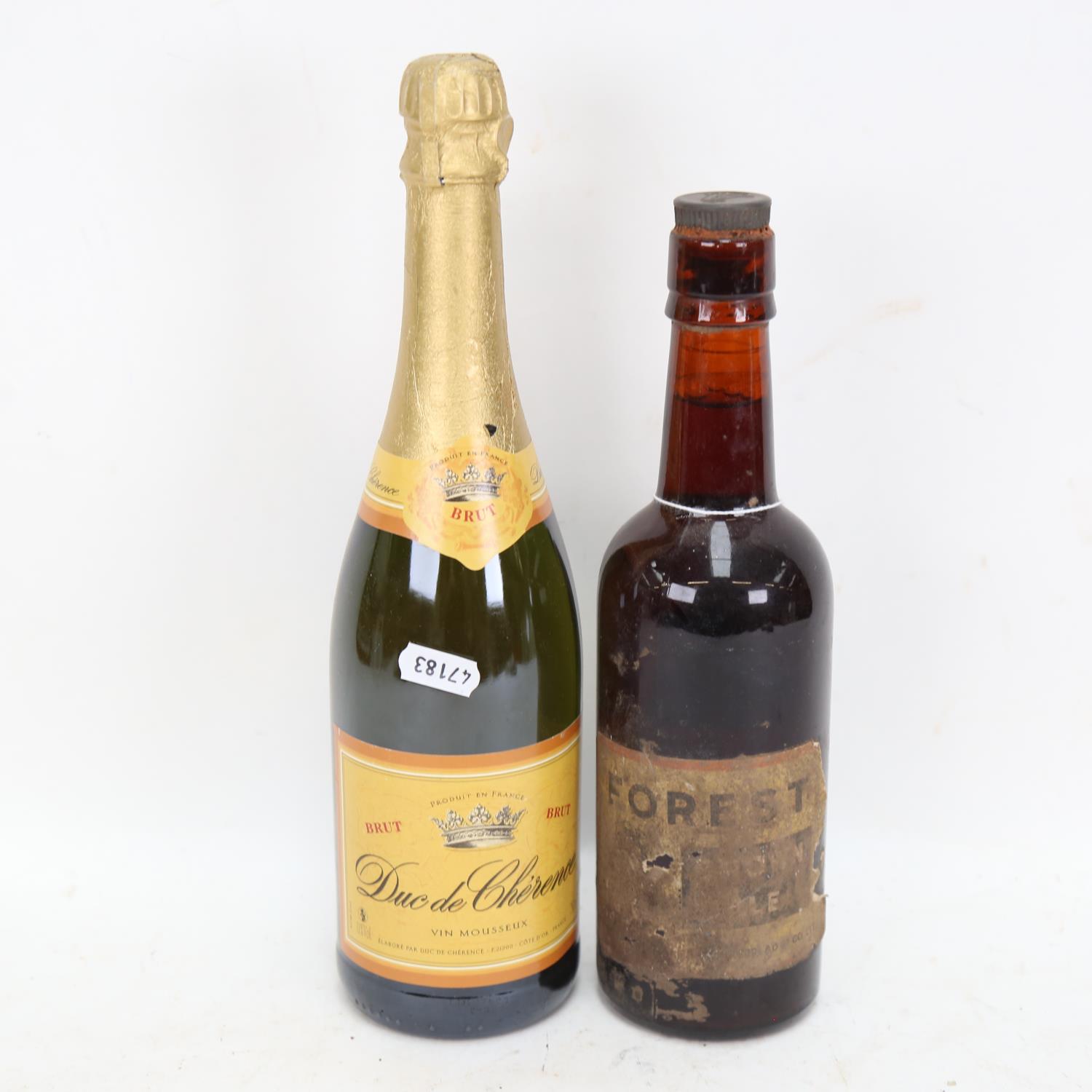 A bottle of Forest Brown Ale, and a bottle of Duc De Cherence Vin Mousseux