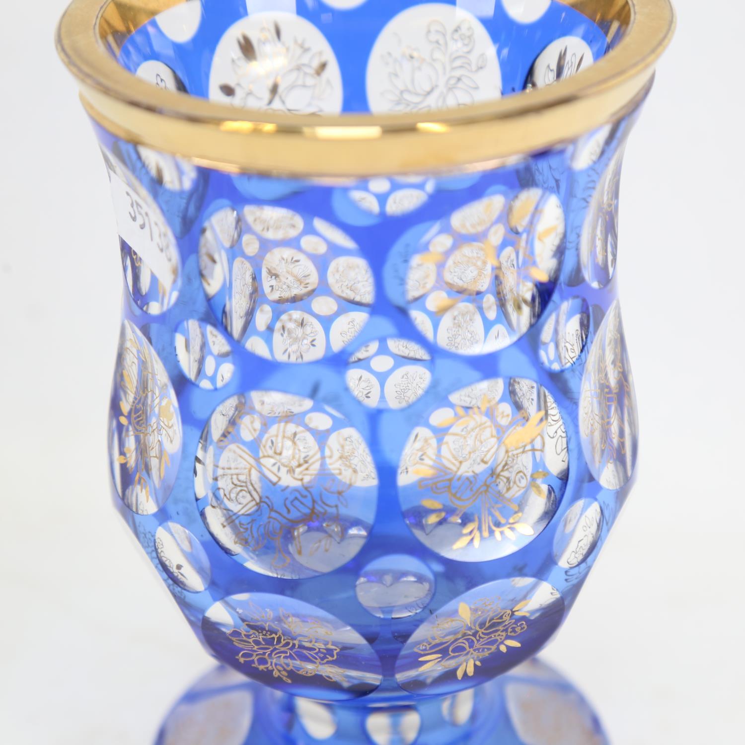 A heavy Bohemian flashed blue overlay glass goblet, gilded instrument and floral decoration, with - Image 2 of 2