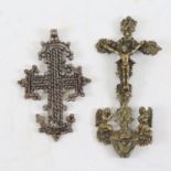 An Ethiopian cross pendant, length 12cm, and a Continental relief cast-brass cross, height 16cm (2)