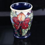 A modern Moorcroft Lily pattern vase, tube-lined decoration, dated '99, height 14cm