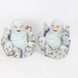 A pair of Chinese ceramic seated Buddhas with children, height 20cm (2)