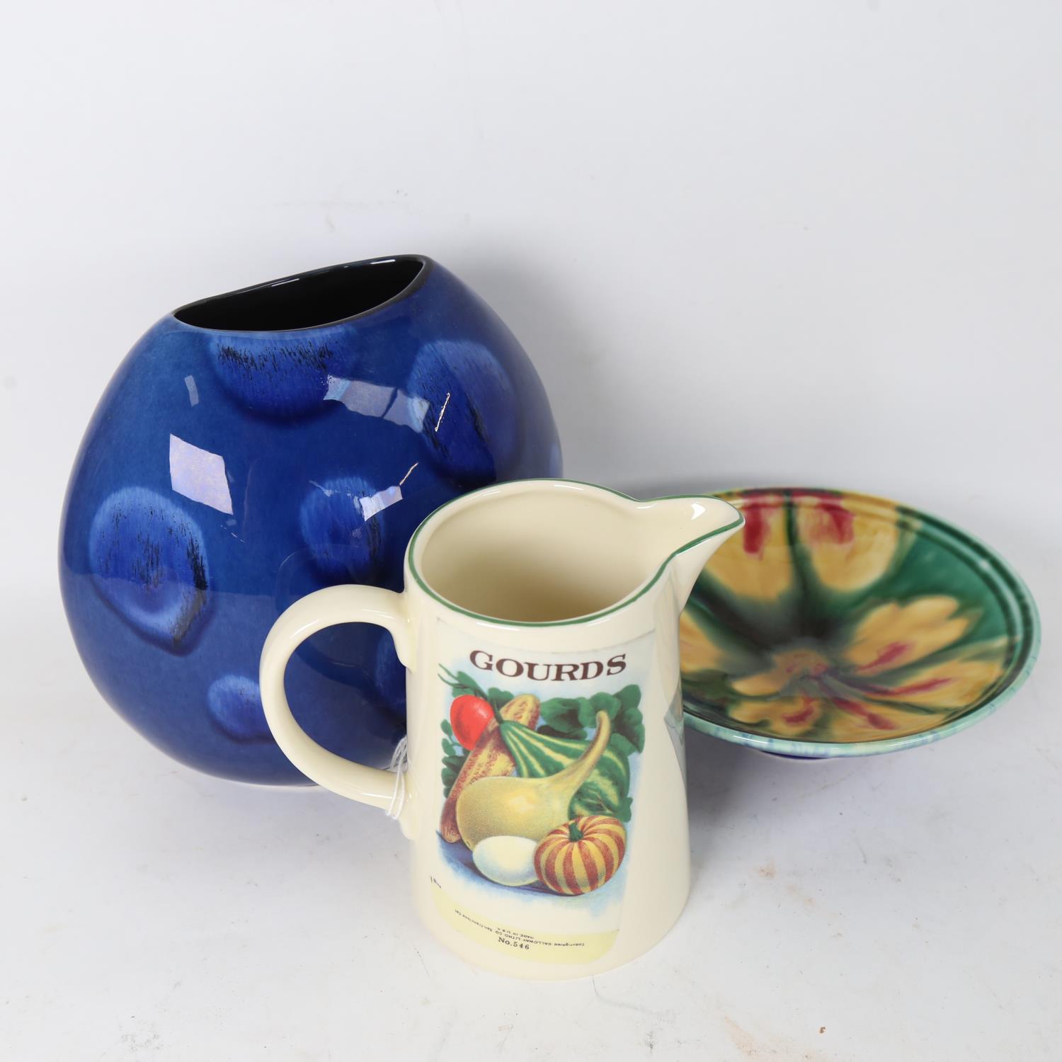 A Poole Pottery yellow flower dish, and a Poole Pottery Seed Packets jug, height 14cm (2)