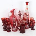 A set of cranberry overlay etched glass, including Whisky decanter, small tankard, goblets etc