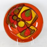 A Poole Pottery orange and green ground fruit bowl, model no. 89, diameter 23cm