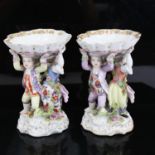 A pair of Augustus Rex figural porcelain table salts, with hand painted figural and floral supports,