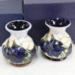 A pair of modern Moorcroft Pottery squat vases, tube-lined decoration with blue flowers, dated 2005,