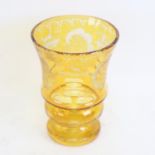 A Bohemian flashed yellow glass overlay drinking glass, with etched decoration and polished pontil,