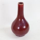 A small Chinese sang de boeuf pottery bottle vase, height 17cm
