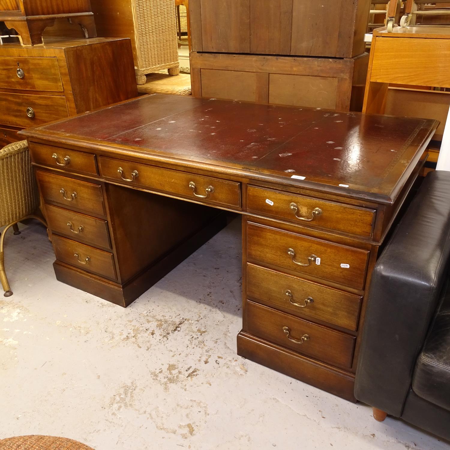 A mahogany twin-pedestal writing desk with fitted drawers, W153cm, H76cm, D91cm, kneehole width