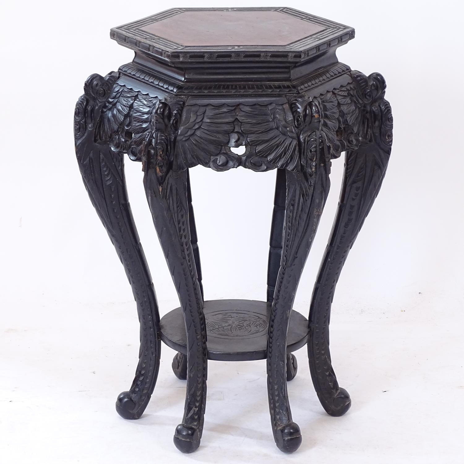 A Chinese carved wood octagonal jardiniere stand