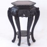 A Chinese carved wood octagonal jardiniere stand