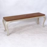 A rectangular polished and painted bench on cabriole legs, L140cm, H46cm, D38cm