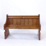 A small polished pine Gothic design bench, with panelled back and shaped sides, L127cm, H84cm, D48cm