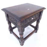 A small carved oak sewing box on turned legs, W44cm, H44cm, D31cm