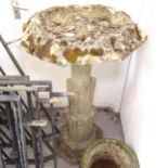 A weathered concrete birdbath, on an Art Deco style column support, W65cm, H107cm