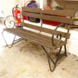A hardwood slatted garden bench, on scrolled wrought-iron frame, L126cm
