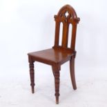 A Victorian mahogany Gothic hall chair, on ring turned legs