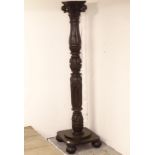 An Antique carved oak torcher stand, on platform base and replacement bun feet, H139cm
