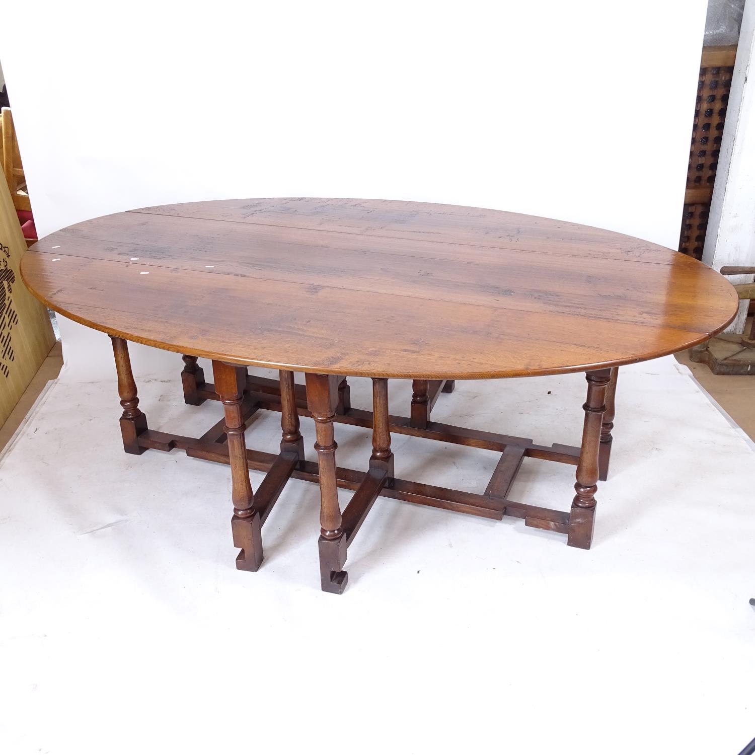 A good quality reproduction oak drop leaf wake table, on baluster turned legs, L227cm, H78cm, W52cm