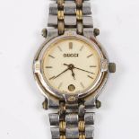 GUCCI - a lady's bi-metal 9000L quartz bracelet watch, cream dial with gilt baton hour markers, date