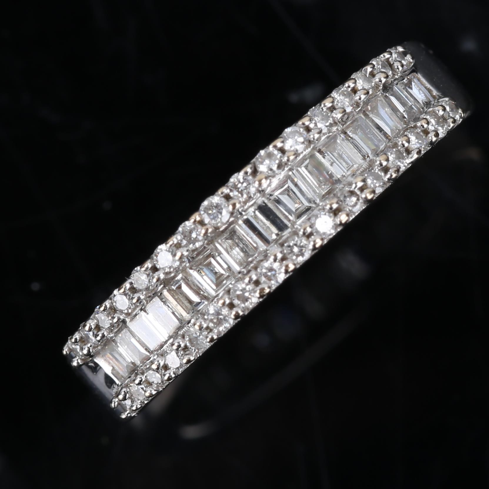 A modern 18ct white gold diamond cluster half hoop band ring, set with baguette and round