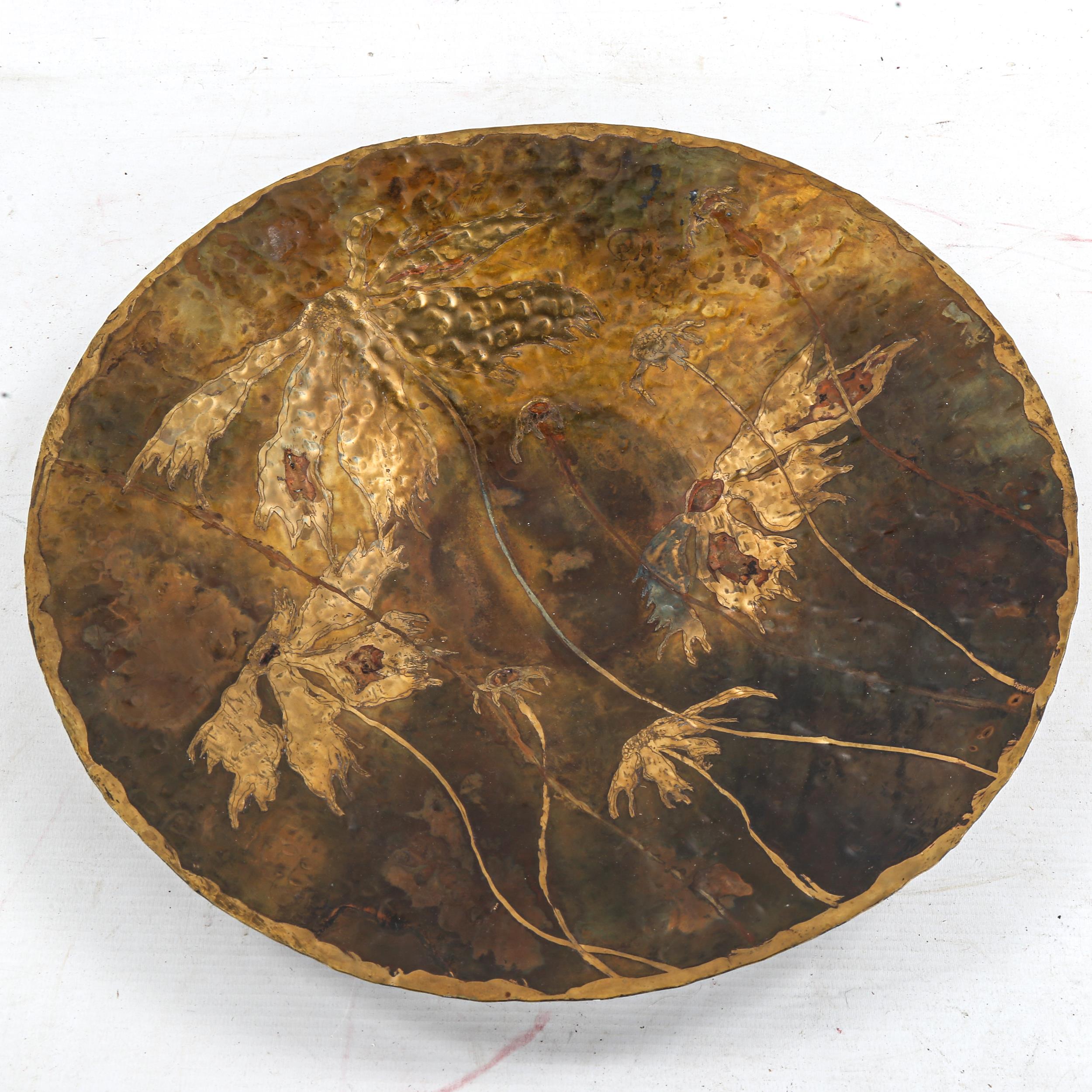 An Arts and Crafts hammered copper bowl, with brass inlaid decoration, indistinctly signed Valerie