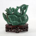 A Chinese carved greenstone bird, on hardwood stand, height 16cm