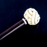 An exotic wood walking stick, with relief carved ivory crown knot design handle