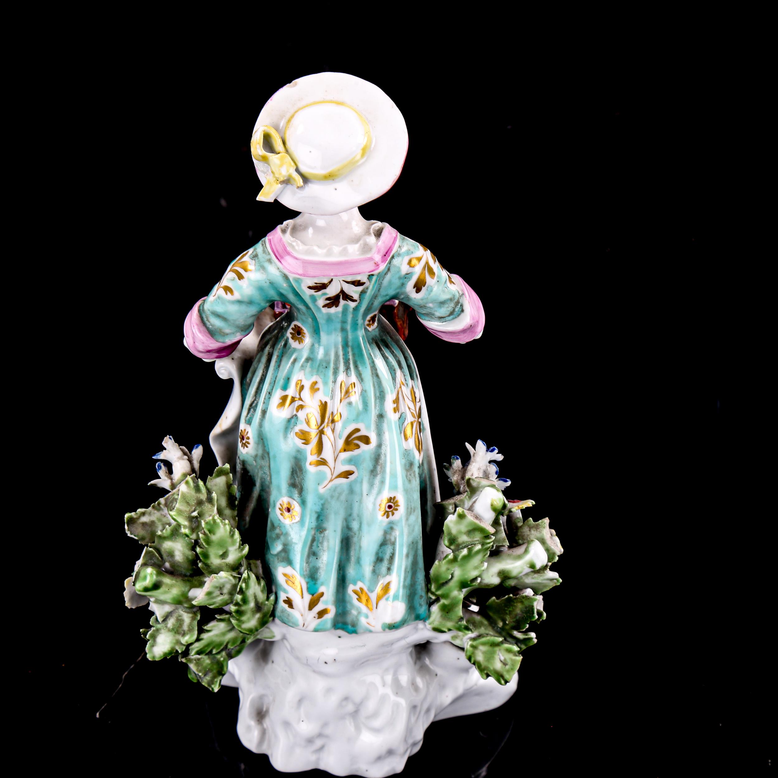 A 19th century porcelain figure, woman selling trinkets, height 15cm - Image 2 of 3