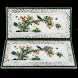 A pair of Chinese porcelain plaques, with painted birds and blossom, in embossed surrounds, 31cm x