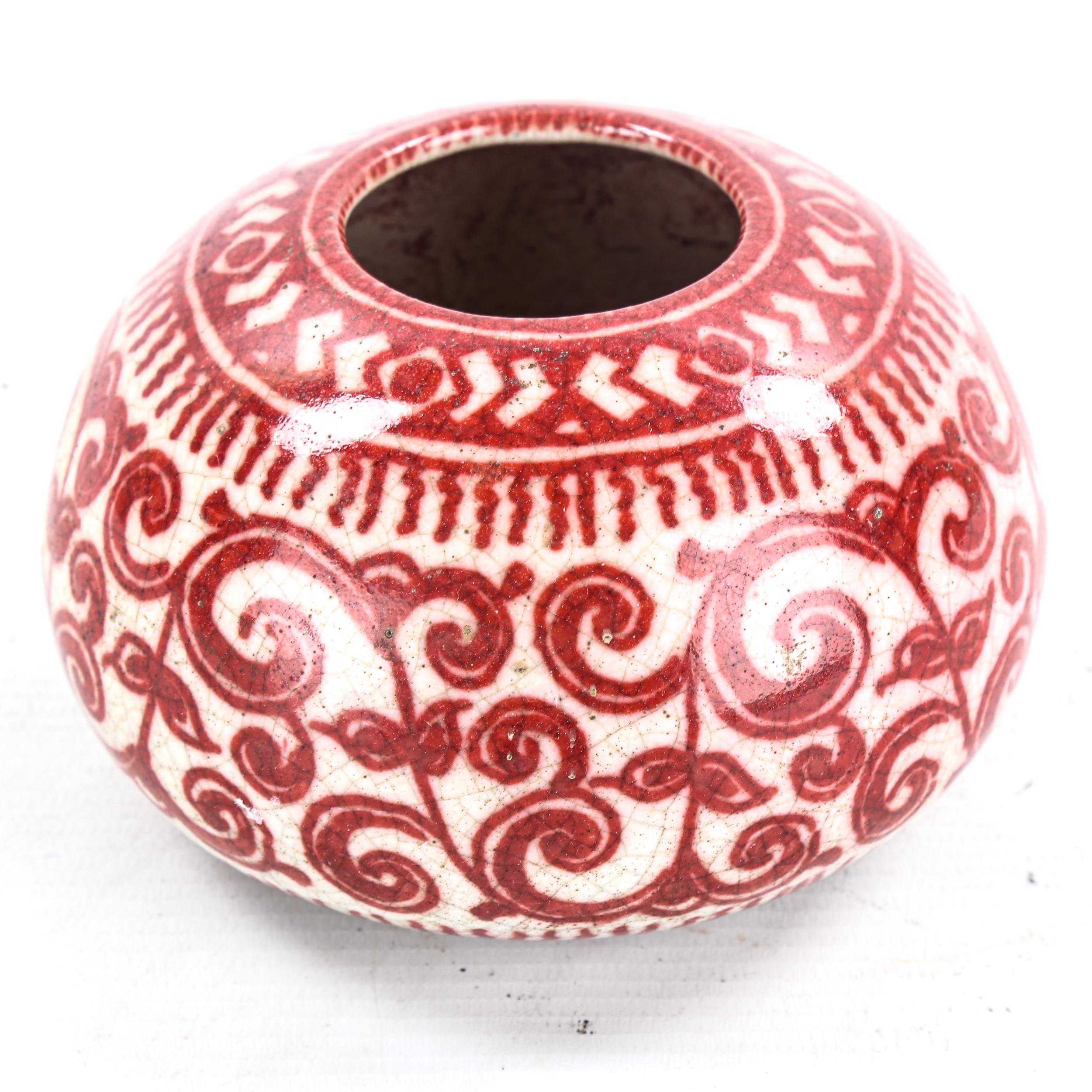 A Delft Pottery vase, with hand painted iron red design, signed with monogram, diameter 12cm